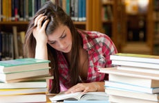 College student studies in library