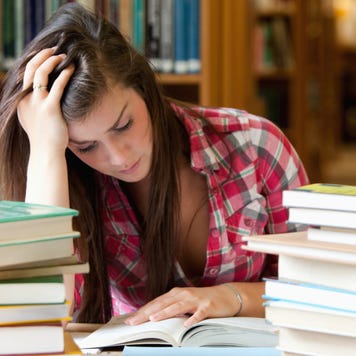 College student studies in library