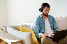 Man wearing headphones using computer