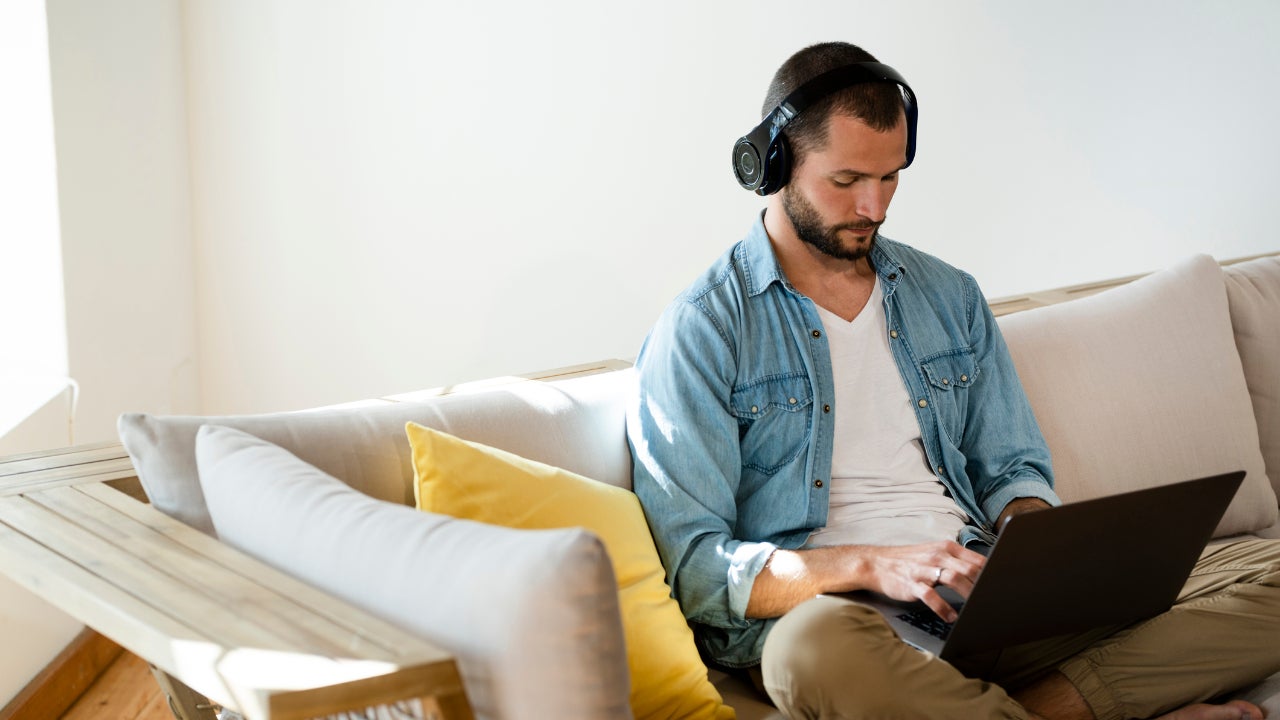 Man wearing headphones using computer