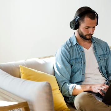 Man wearing headphones using computer