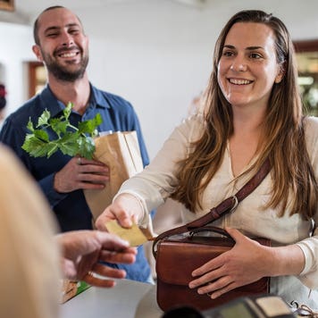 woman paying at counter with credit card