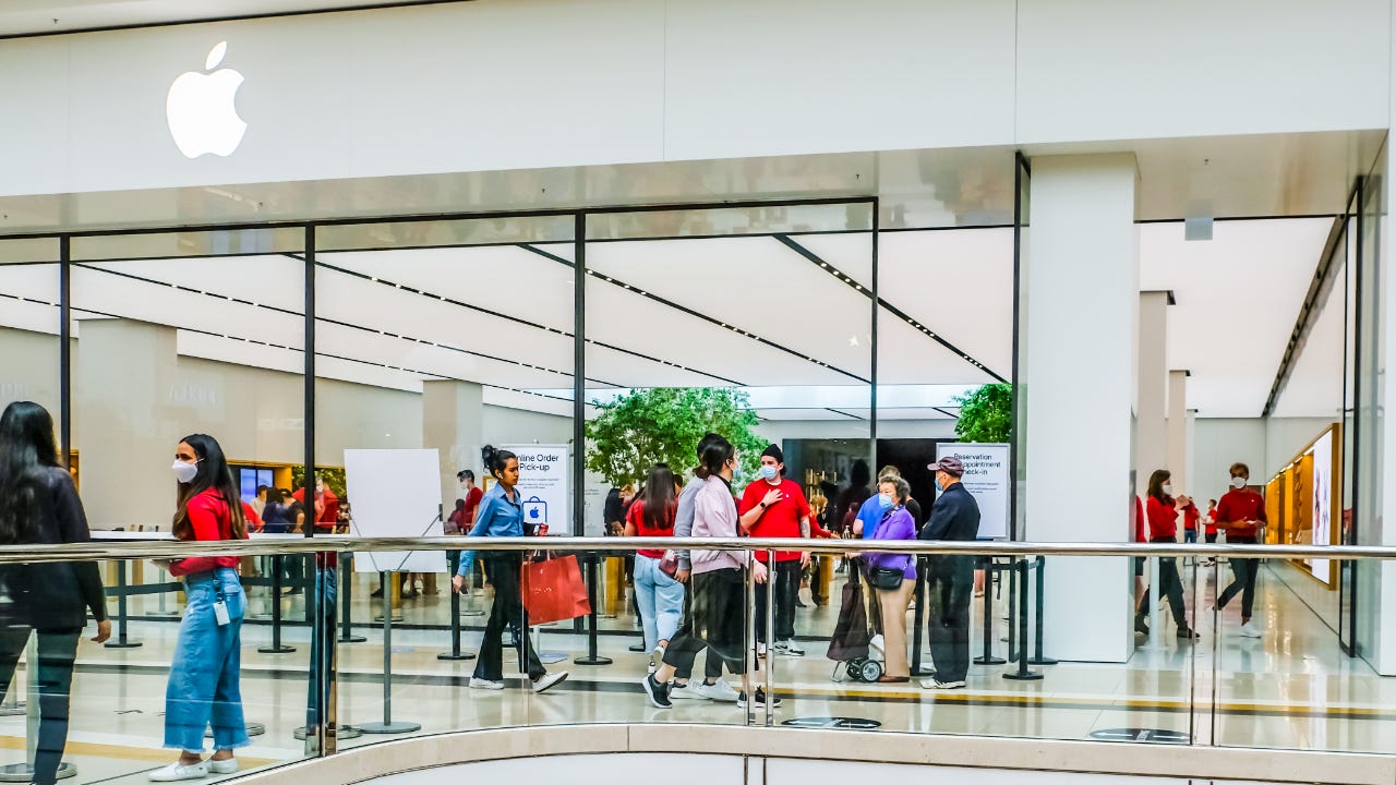 An Apple store in Chadstone Shopping Centre with Apple staff wearing red T-shirts and face masks as a precaution against the spread of covid-19.