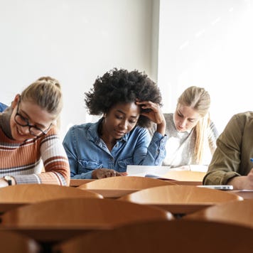 Students take notes in a college classroom