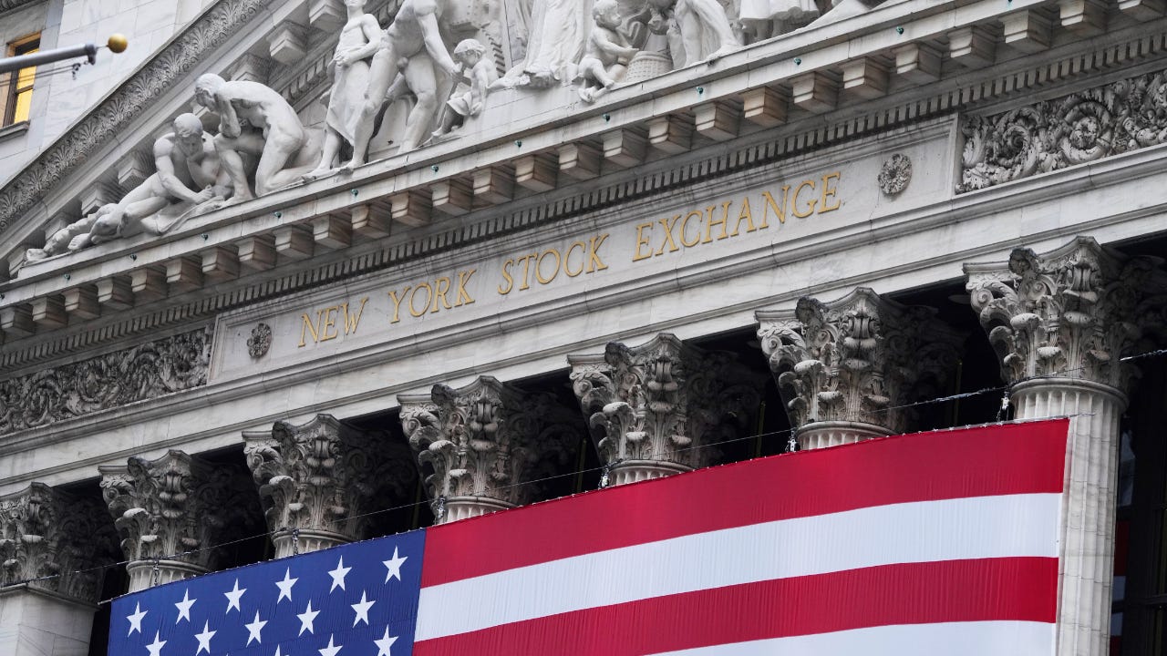 A picture of the New York Stock Exchange with an American flag draped on it
