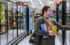 Woman grocery shopping in Walmart during pandemic