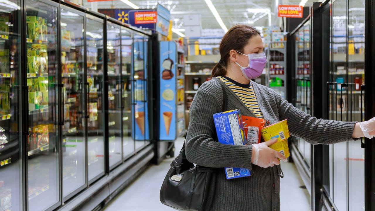Woman grocery shopping in Walmart during pandemic