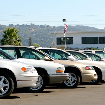 Used cars on a lot parked side by side