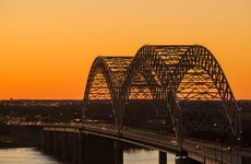 The famous, iconic bridge leading into Memphis at twilight.