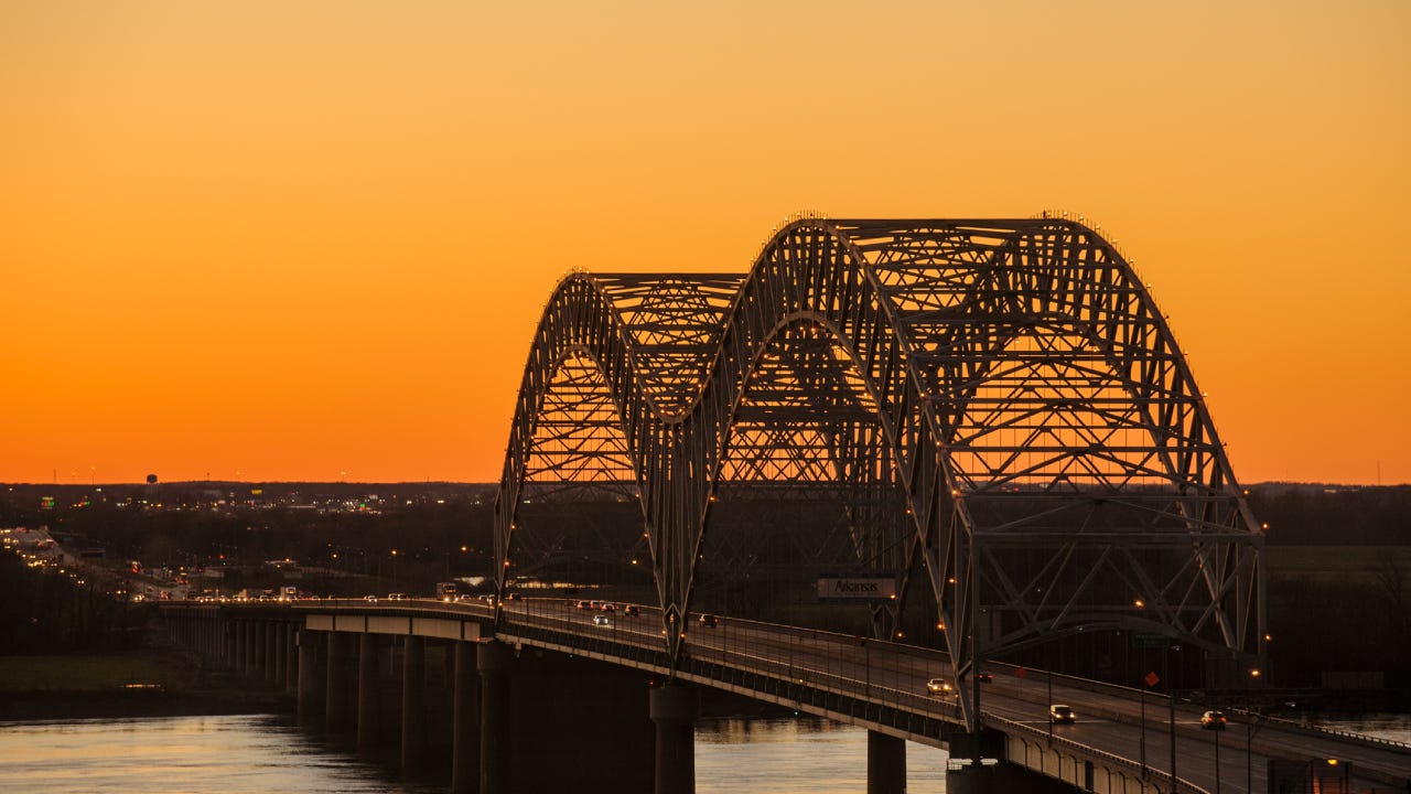 The famous, iconic bridge leading into Memphis at twilight.