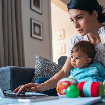 Mom at home on computer with her young son