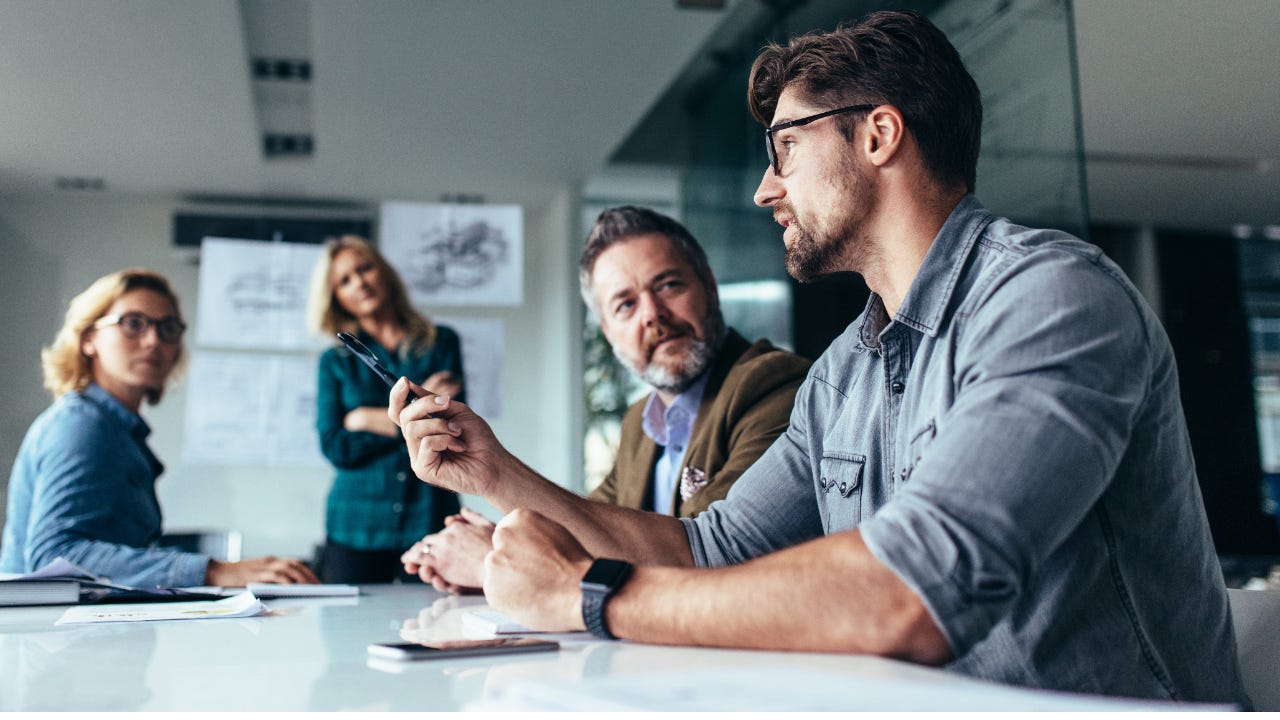 Young man leading a business meeting