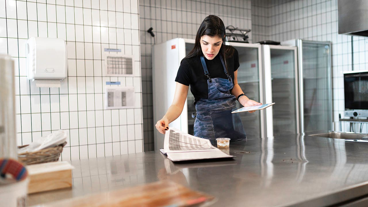 woman taking inventory in an industrial kitchen