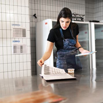 woman taking inventory in an industrial kitchen
