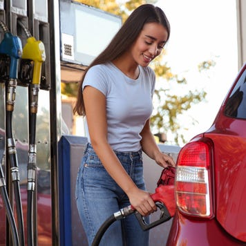 Woman pumping gas