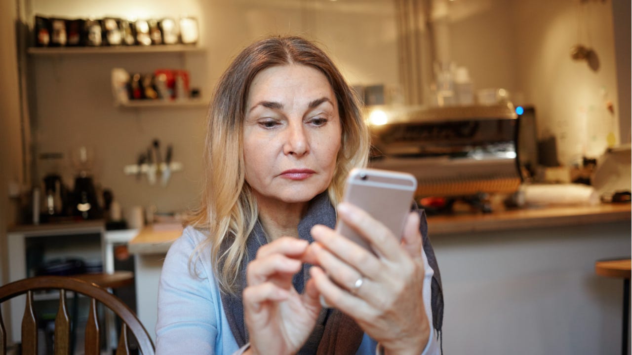 woman concentrating on cell phone