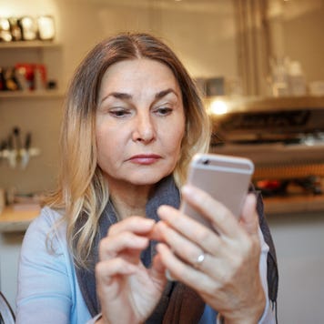 woman concentrating on cell phone