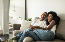 A black couple sitting together on the couch