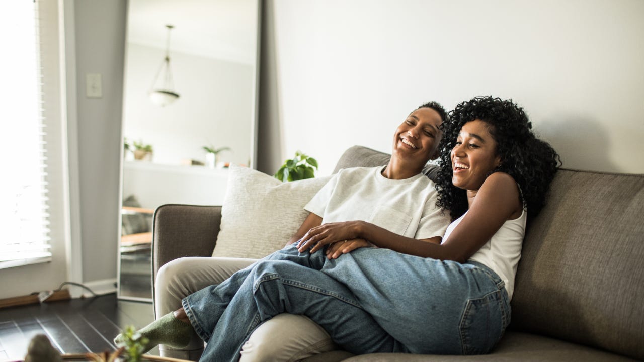 A black couple sitting together on the couch