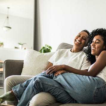 A black couple sitting together on the couch