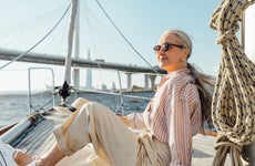A woman relaxes on a boat.