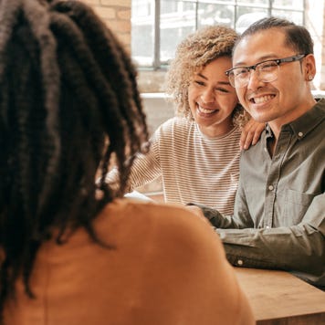 Asian interracial family discussing life insurance possibilities with agent