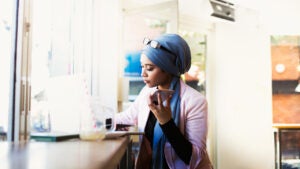 Woman using laptop in cafe