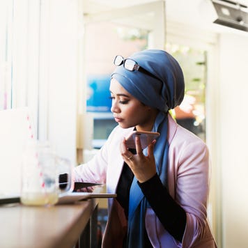 Woman using laptop in cafe