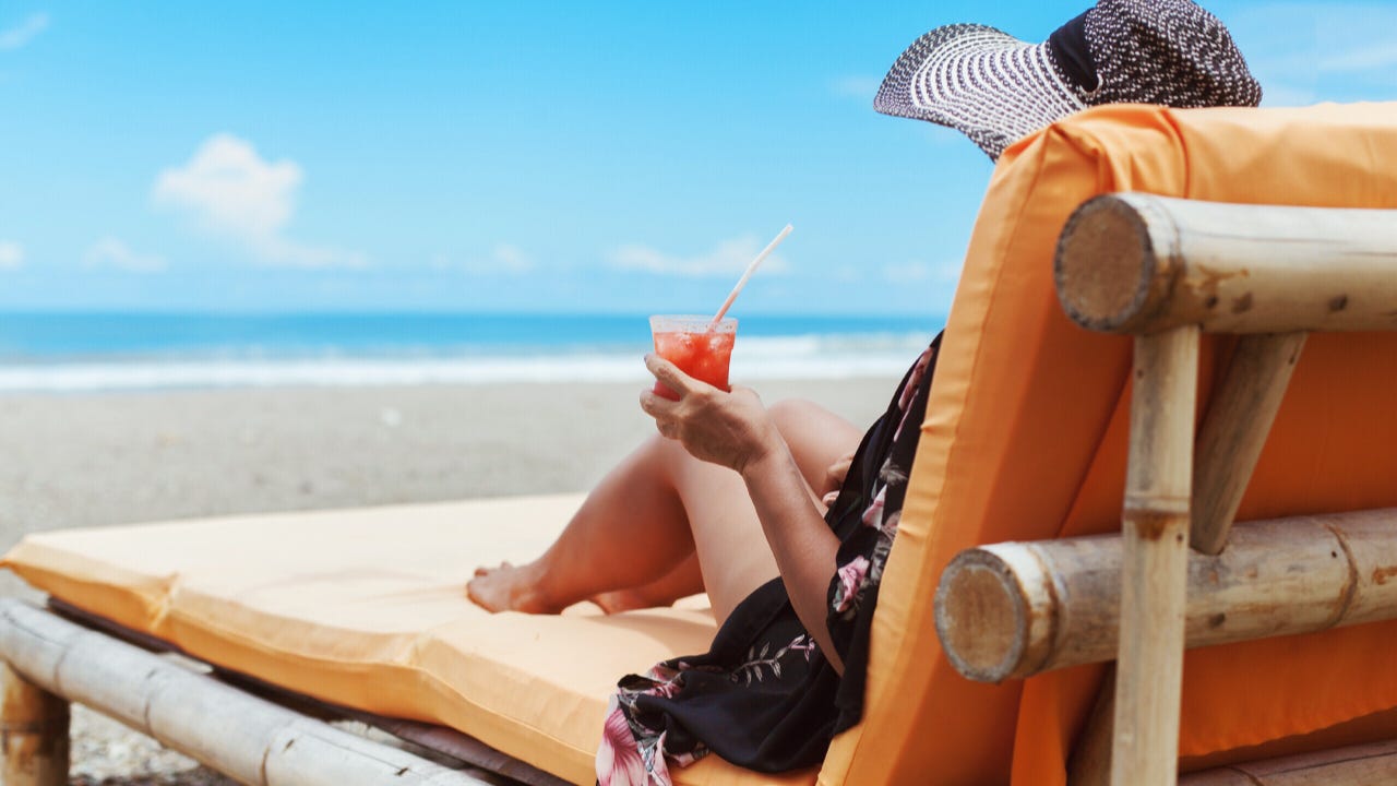 A woman lounges on the beach.