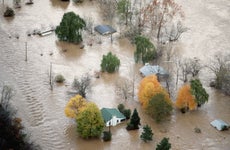 An Aerial View of Houses Surrounded by Flood Water