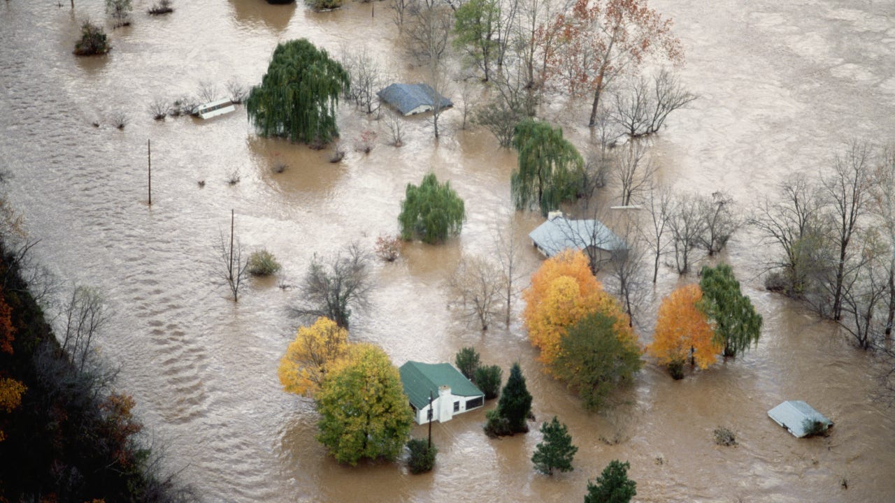 An Aerial View of Houses Surrounded by Flood Water