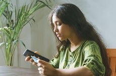 Woman using credit card and cellphone
