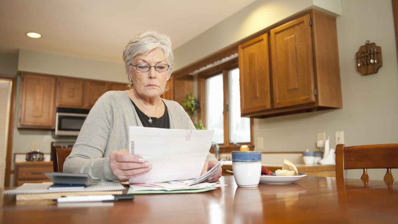 Old woman looking at her finances