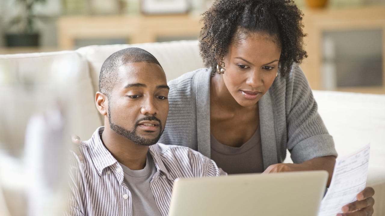 Black couple looking at finances