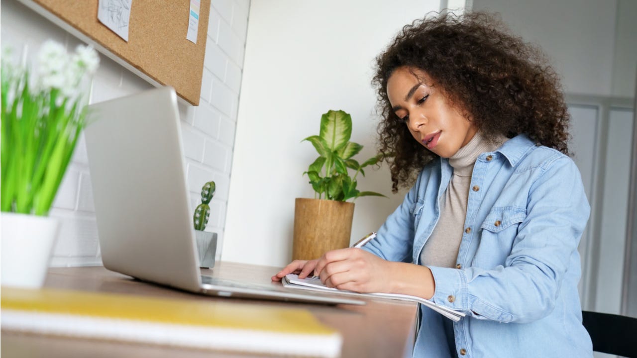 Woman works on laptop at a desk