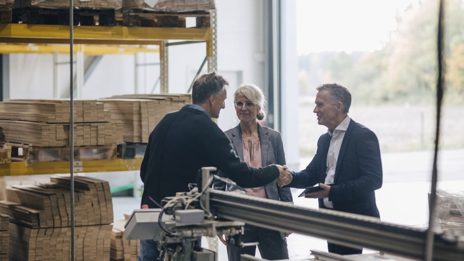 A businessowners shaking hands with an life insurance rep