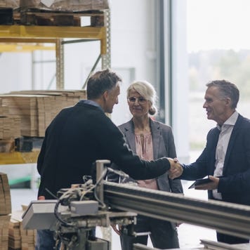 A businessowners shaking hands with an life insurance rep