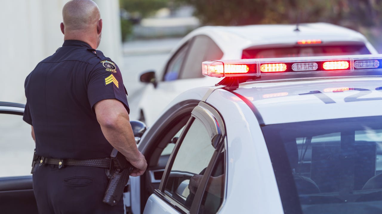 Police officer getting out of cruiser