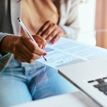 close up of hands filling out paperwork