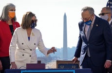 Nancy Pelosi and Chuck Schumer sign stimulus relief bill