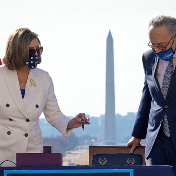Nancy Pelosi and Chuck Schumer sign stimulus relief bill