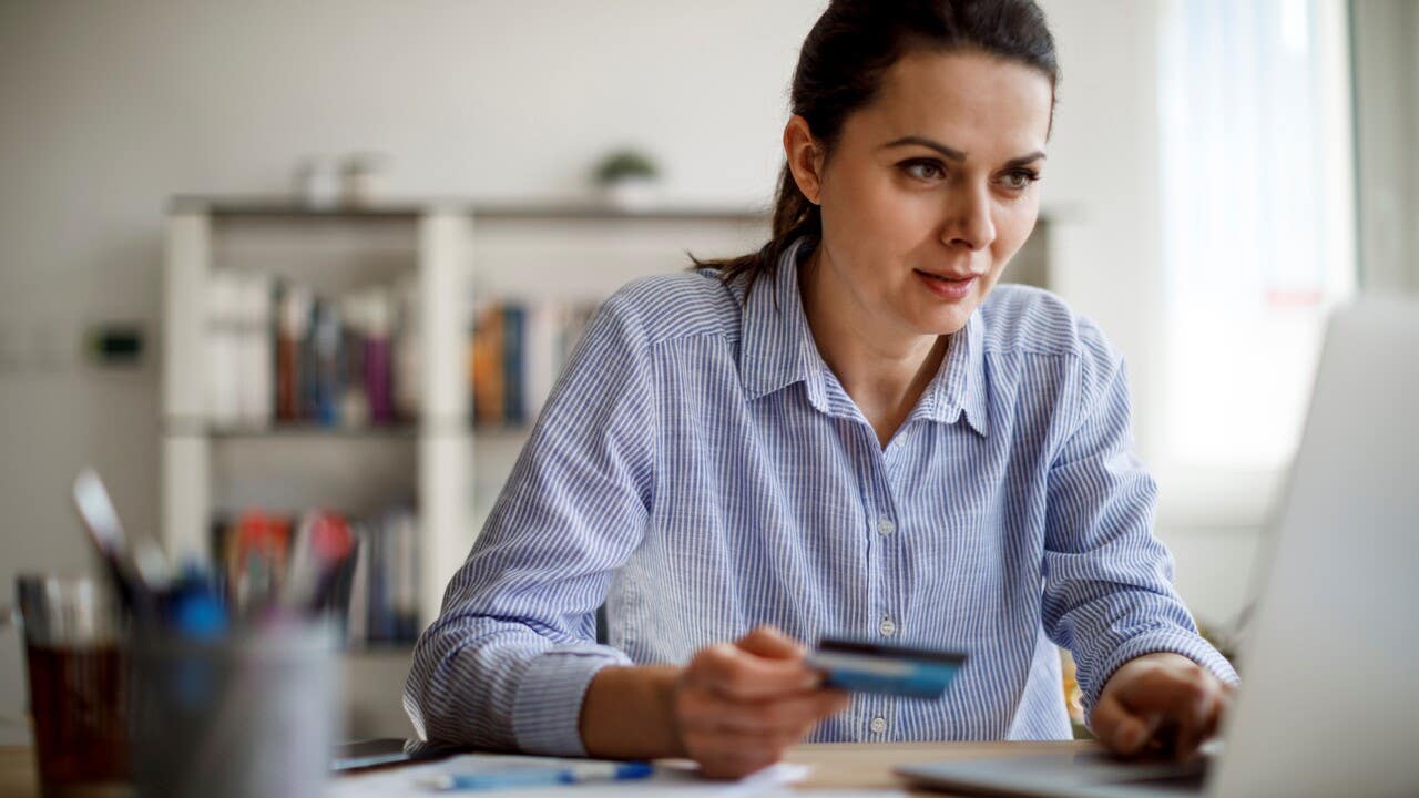 Woman paying bills with a credit card