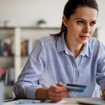 Woman paying bills with a credit card