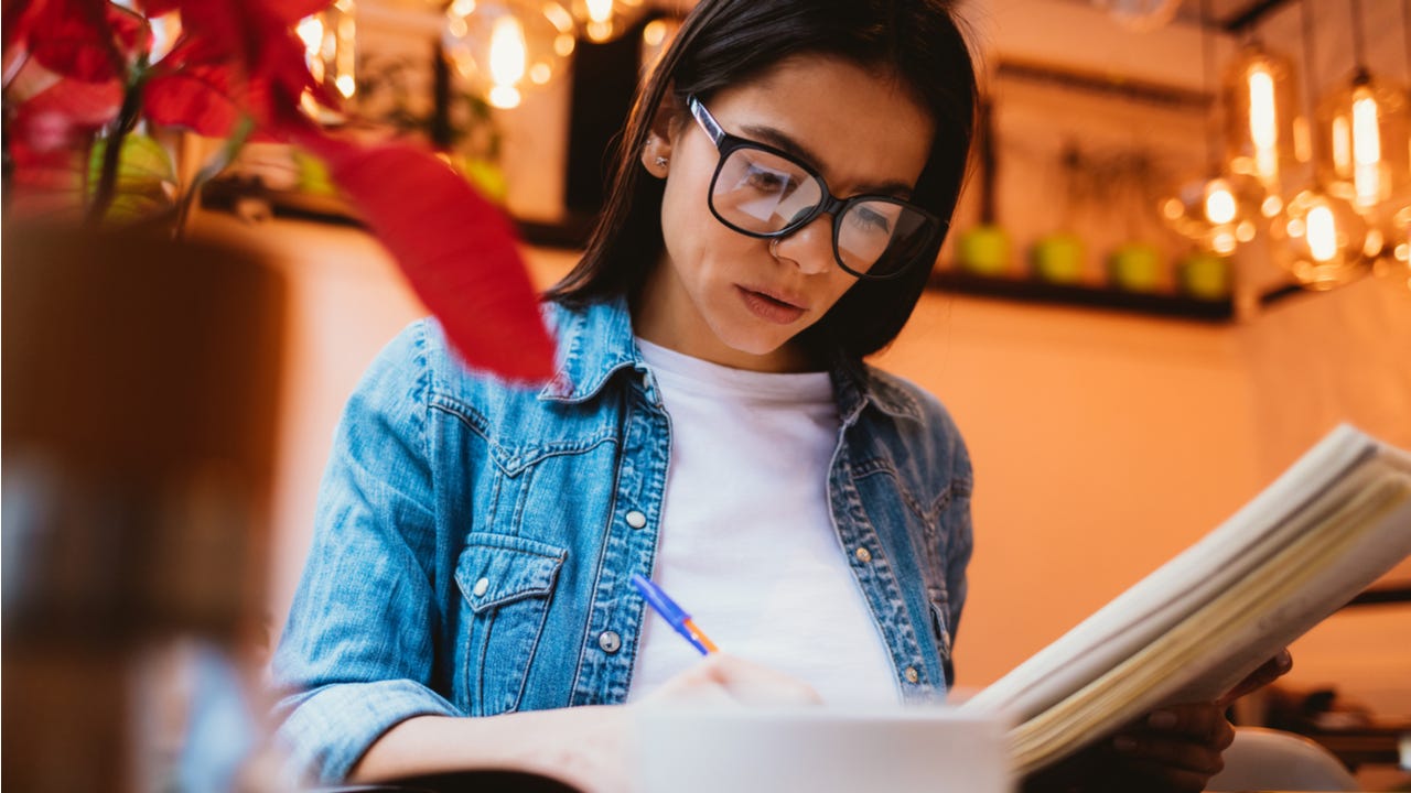 Woman does homework in a cafe