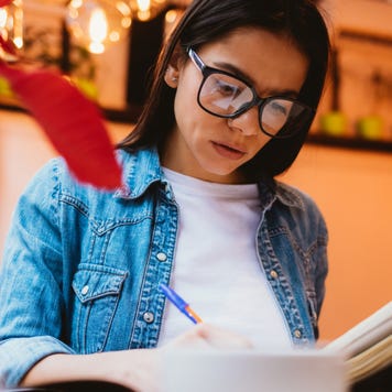 Woman does homework in a cafe