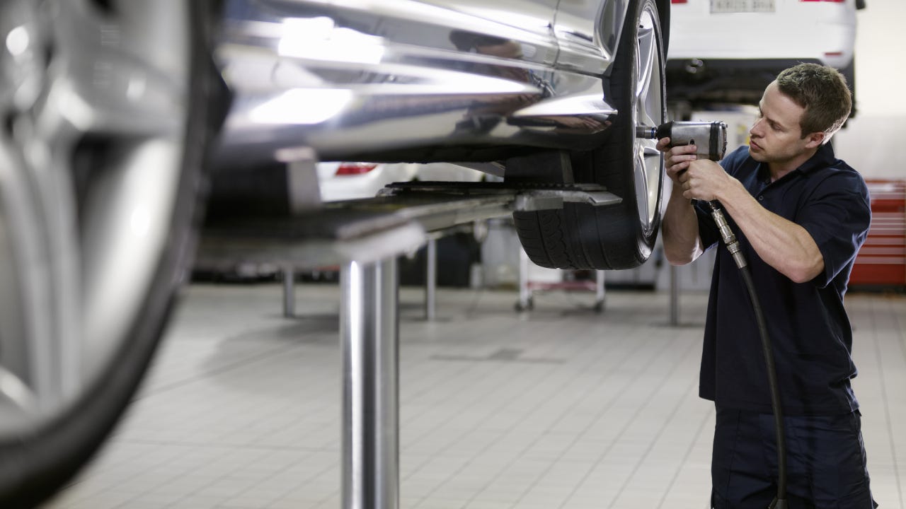 Mechanic working on car in auto repair shop