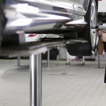 Mechanic working on car in auto repair shop