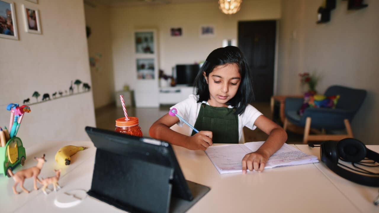 Young girl attending virtual school