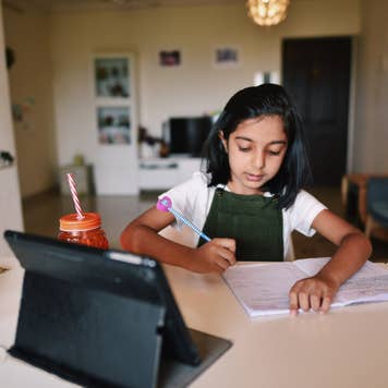 Young girl attending virtual school