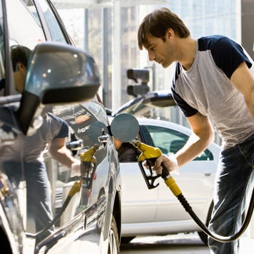 Man refueling vehicle at gas station